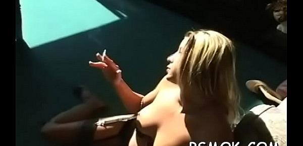  Beauty enjoys a cigarette whilst putting a dick in her mouth